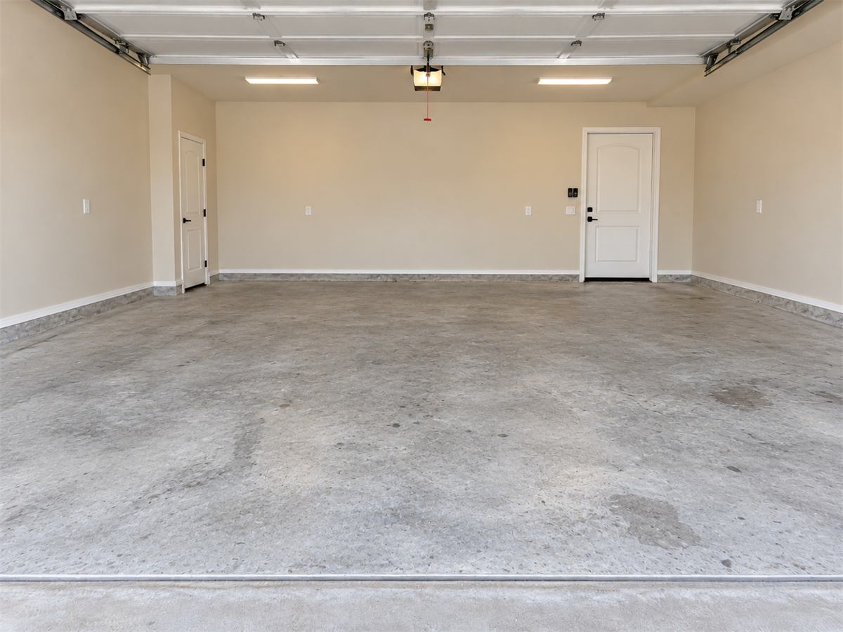 Bare, unfinished concrete garage floor before coating