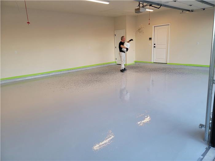 Tulsa Floor Coatings crew member applying the polyurea base coat during installation