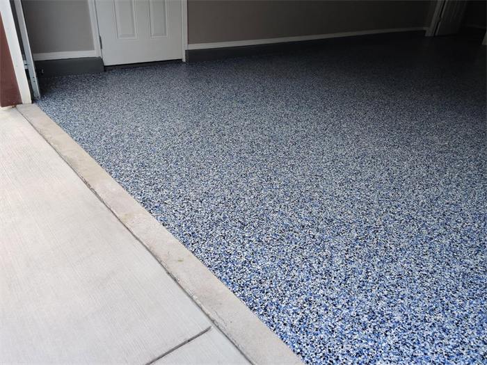 Coastal blue decorative flake garage floor coating near the entry doorway