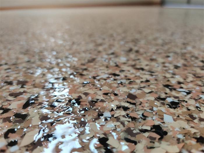 Close-up detail of a custom decorative flake color blend during application